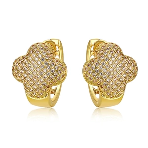 Macro detail of 18K gold clover earrings featuring micro-paved sparkling cubic zirconia