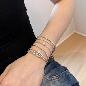 Close-up of S925 sterling silver bracelets with pear-cut cubic zirconia on a model wrist