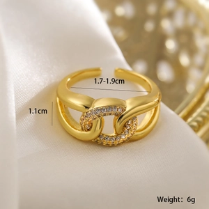 Macro shot of 18K gold plated interlocking rings with zircon on white silk