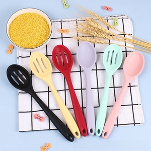 Set of 6 colorful food-grade silicone kitchen spoons and slotted strainers on a napkin