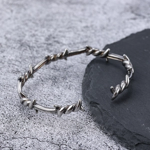 Macro detail of the punk style barbed wire texture on a vintage stainless steel cuff bracelet