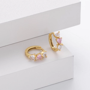 Detail showing S925 silver gold-plated huggie earrings with pink and white heart zircons