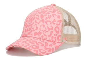 Detail showing the pink leopard print fabric and breathable beige mesh on a trucker hat