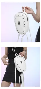 Detail of white pebbled leather Gothic backpack featuring silver studs and skull emblem