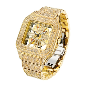 Detailed close-up of golden square watch with iced-out crystals and hollow dial