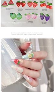 Macro detail of 3D resin fruit nail art charms including watermelon and strawberry