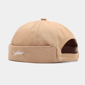 Detail view of khaki cotton docker hat showing white Asher embroidery and adjustable back