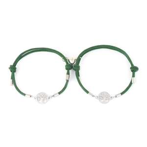 Detail of forest green braided couple bracelets with tree of life charm and heart magnet