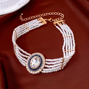Vintage multi-layer pearl necklace with a large crystal oval pendant and gold finish