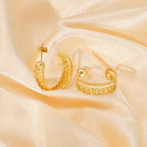 Detailed shot of 18K gold plated chain link earrings on soft beige silk fabric