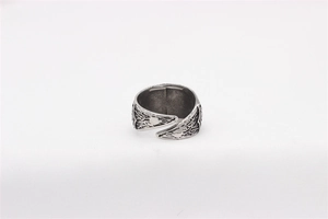 Detail of vintage silver adjustable viking ring with intricate feather texture