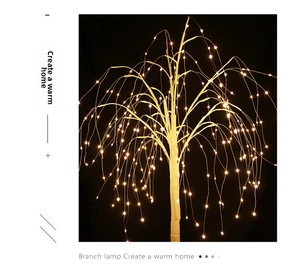 Detail of warm yellow micro LED lights on white weeping willow tree branches for decor