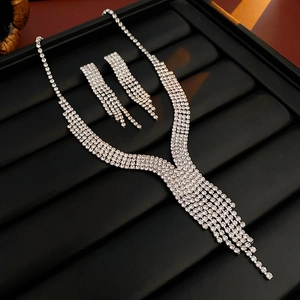 Detail of silver water drop tassel jewelry set with sparkling rhinestones on black tray