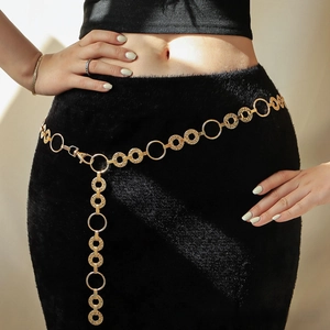 Detailed macro view of golden metal chain belt featuring textured round disc pendants