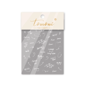 Detailed view of white handwritten calligraphy nail stickers with MS-106 artistic phrases