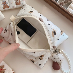 Quilted cotton bag detail showing inner space with a phone and cute bear plush charm