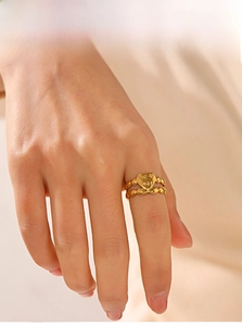 Detailed macro view of the gold heart charm with For Best engraving and beaded band