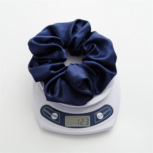 Detailed scale view showing the 12.3g weight of this large navy blue satin hair scrunchie