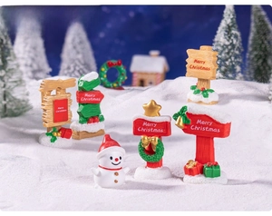 Miniature resin Christmas signposts and snowman figurines in a snowy DIY landscape