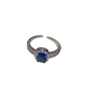 Adjustable silver ring featuring a blue oval gemstone with sparkling zircon halo setting