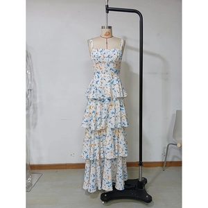 Detail of white floral chiffon tiered maxi dress with blue and orange flower print