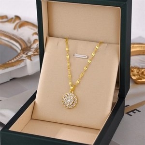 Golden rotating circular necklace with sparkling zircon crystals in a luxury gift box