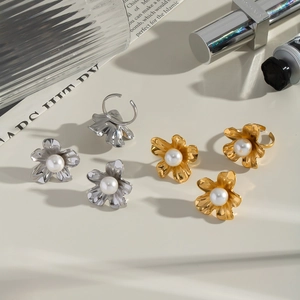 Detail shot of pearl flower earrings and ring in gold and silver plating
