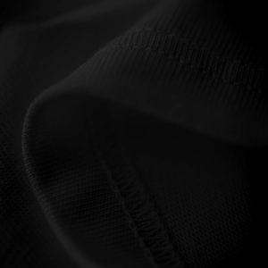 Close-up of black ribbed knit fabric detail with seamless stitching on cotton T-shirt