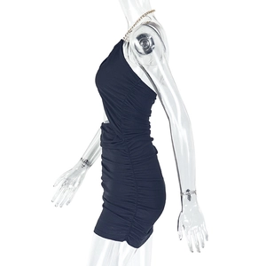 Detail of black bodycon dress featuring a gold chain halter neck and ruched texture
