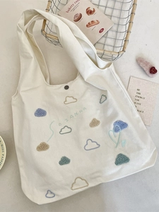 White canvas tote bag with colorful cloud embroidery and S O ZAKKA text in aesthetic style