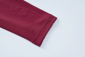 Detailed close-up of burgundy dress sleeve with high-quality twin-needle stitching finish