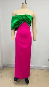 Detail of color-block tube dress featuring rose pink skirt and emerald green shawl bodice