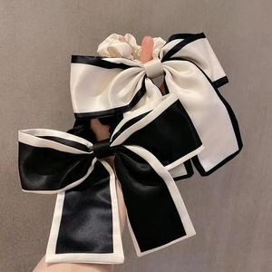 Satin oversized bow hair scrunchies in classic black and white contrast design