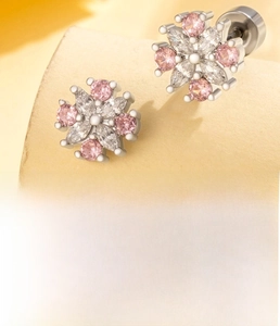Detail of flower stud earrings with pink and white cubic zirconia on titanium steel rod