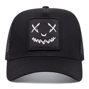 Street style black mesh trucker hat with white embroidered devil smile logo