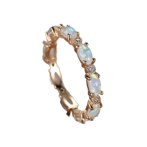 Elegant rose gold wave ring featuring oval white opals and sparkling zircon accents