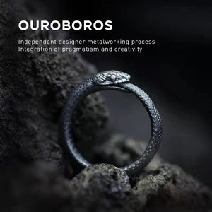 Handcrafted 925 sterling silver Ouroboros ring with detailed scales on black stone