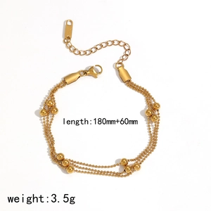 Detailed view of layered gold-tone beaded bracelet with length and weight dimensions