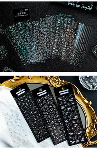 Macro shot of 12 sheets holographic star stickers for journaling on dark glitter backdrop