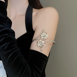 Detail of silver multi-layer floral arm cuff with adjustable double flower design