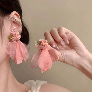 Detail of pink fabric flower tassel earrings with silk petals and beaded accents