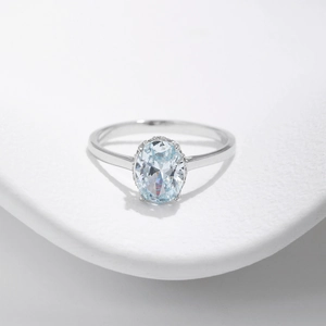 Elegant S925 sterling silver ring featuring a light blue oval crystal and diamond halo
