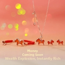 Detail of red dala horse jewelry set with gold necklace, woven bracelet and stud earrings
