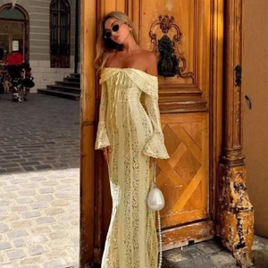 Elegant light yellow lace off-shoulder long-sleeve dress displayed by model outdoors