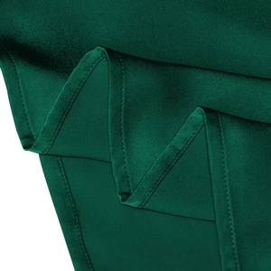 Detail of dark green satin fabric showing smooth texture and high-quality stitching