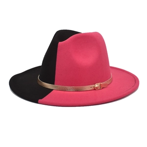 Detail of two-tone black and fuchsia wool fedora hat with gold buckle and leather strap