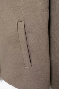 Detail view of the side pocket on a khaki wool coat with high-quality stitching
