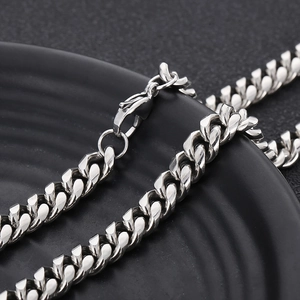 Macro detail of silver titanium steel Cuban chain link necklace with lobster clasp closure