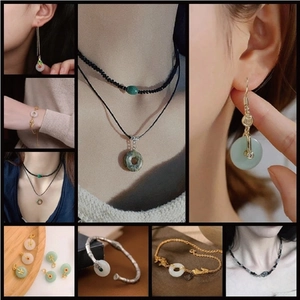 Detailed close-up of jade-like gemstone jewelry set including earrings, necklace, and bracelet