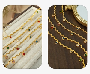 Macro detail of French style wavy gold chain featuring colorful zircon stone pendants